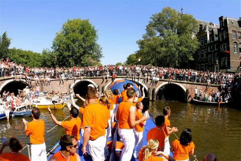 Partying people on a boat in the Amsterdam canal