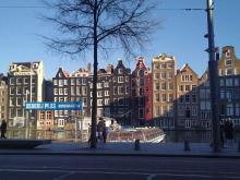 Photo of a boat and canal houses in Amsterdam