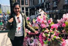 Nipuni standing next to a bike covered in flowers