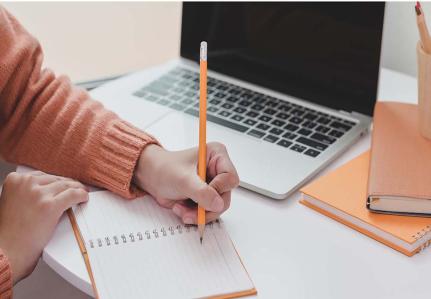 Student writing on a notepad