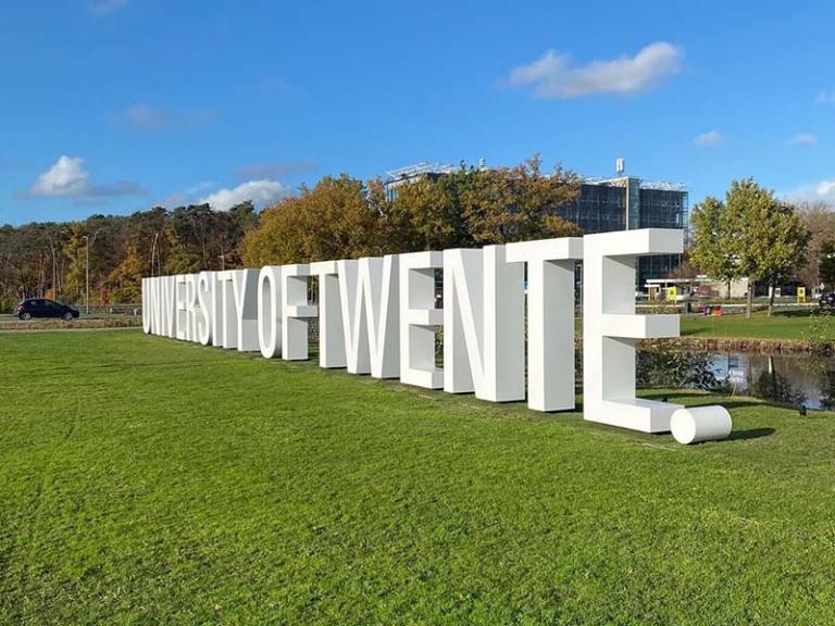 The name University of Twente in large letters on a lawn