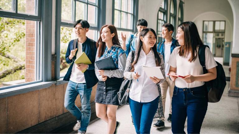 Students walking through a hallway at a school
